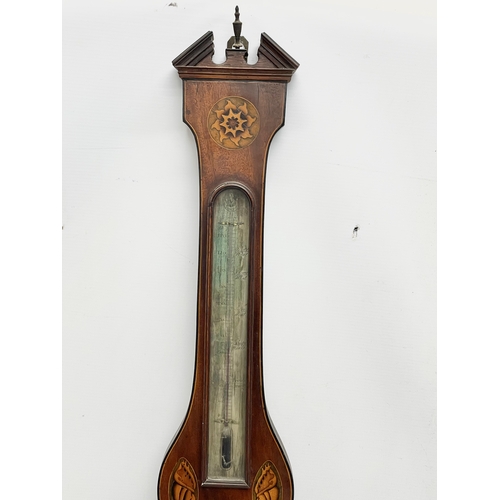 44 - A George IV inlaid mahogany barometer by J. Moretti. Circa 1820. 26x99cm.