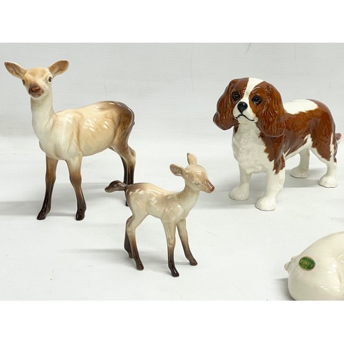 220 - A collection of Beswick pottery animals. ‘Piggy Back’ pigs 17cm. 3 deers, largest 14x15cm. A Beswick... 