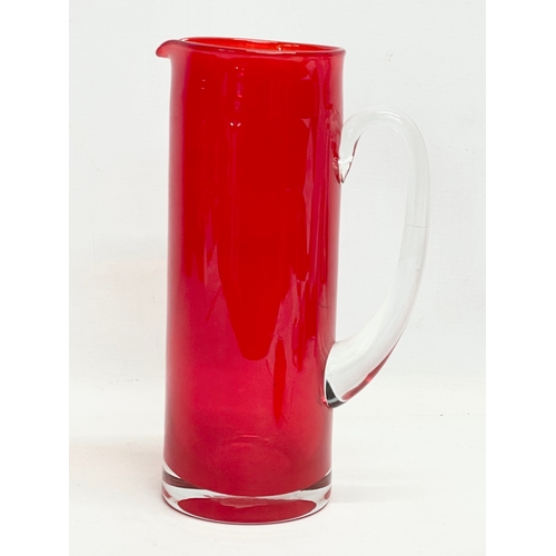 106 - A large Mid Century Swedish style glass pitcher in the manner of Monica Bratt. 27cm