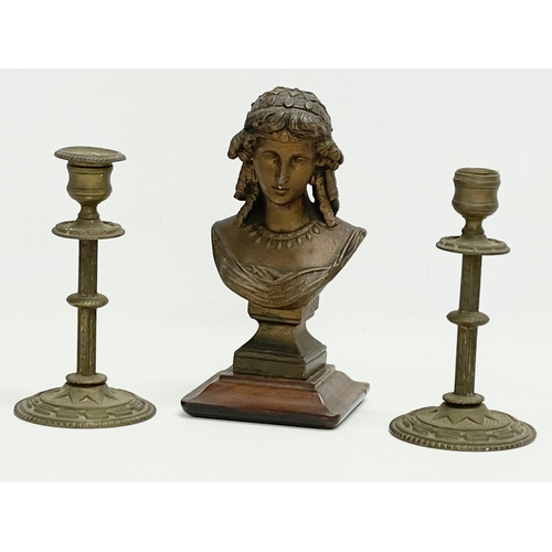 108 - A 19th century spelter bust on stand with a pair of late 19th century brass candlesticks. Bust 10x20... 