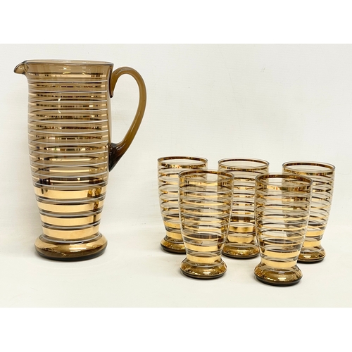 303 - Vintage drinks set. A 6 piece 1970’s gilt smoked glass lemonade drinks set, pitcher measures 17x26cm... 