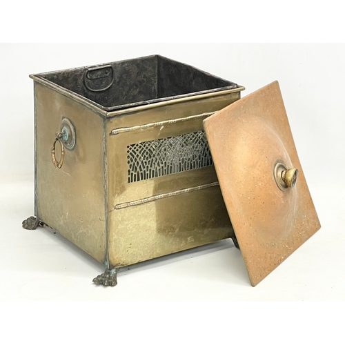 113 - An Edwardian brass coal bin on lion paw feet. 37x33x43cm