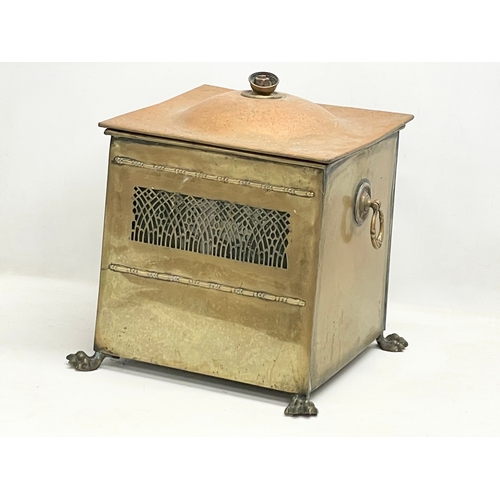 113 - An Edwardian brass coal bin on lion paw feet. 37x33x43cm