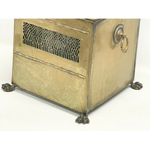 113 - An Edwardian brass coal bin on lion paw feet. 37x33x43cm