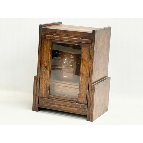 60 - An Edwardian oak humidor smokers pipe cabinet. 21x15.5x28cm