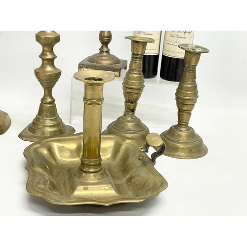 314 - A quantity of Victorian brass candlesticks.