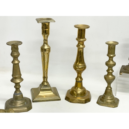 314 - A quantity of Victorian brass candlesticks.