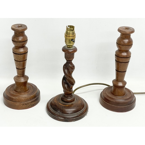 299 - A pair of vintage candlesticks and an oak Barley Twist table lamp. 28cm