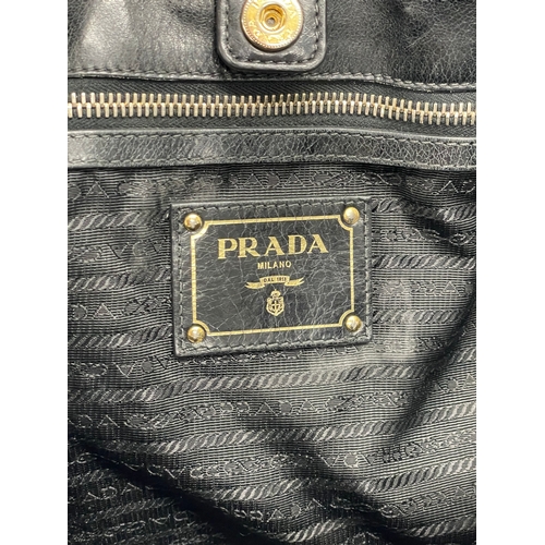 189 - A ladies Prada ‘Vitello’ leather handbag and cover.