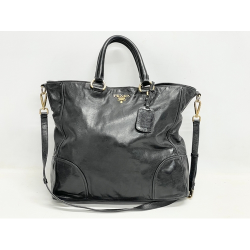 189 - A ladies Prada ‘Vitello’ leather handbag and cover.