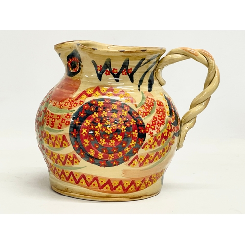 350 - A vintage glazed stoneware jug with twist handle and hand painted decoration. 23x18cm