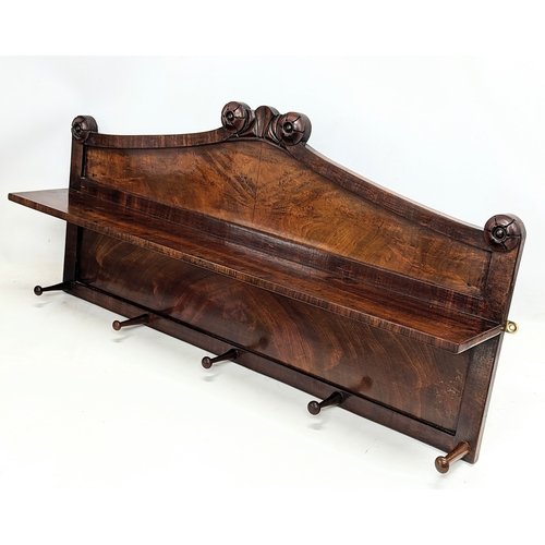 126 - An early Victorian mahogany wall mounted hat and coat rack with shelf and rosette mouldings. 100x54c... 