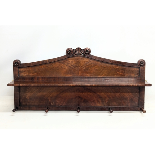 126 - An early Victorian mahogany wall mounted hat and coat rack with shelf and rosette mouldings. 100x54c... 