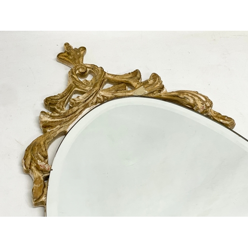 355 - A vintage ornate gilt framed bevelled mirror. 33x75.5cm