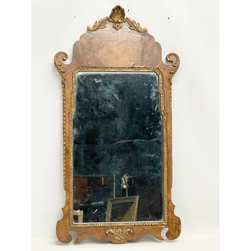 128 - A vintage George II style Burr Walnut and gilt framed mirror. 43x79cm