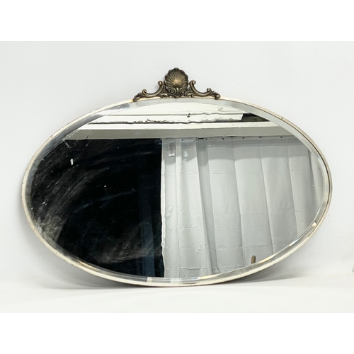 129 - An early 20th century ornate framed bevelled mirror. Circa 1900-1920. 69x47cm