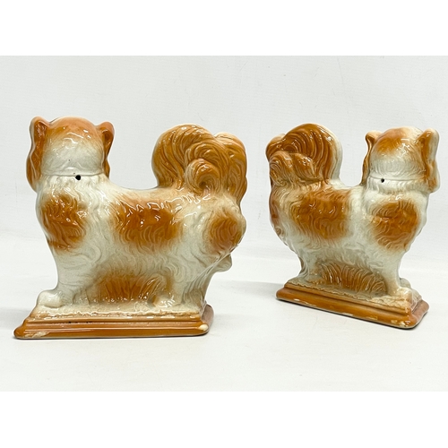 358 - A pair of early 20th century Staffordshire pottery dogs. 21x19cm