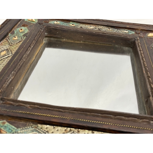 371 - A vintage Islamic style wooden framed mirror. With later back 38x42cm