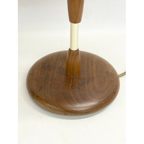 374 - A tall Mid Century teak table lamp. 69cm