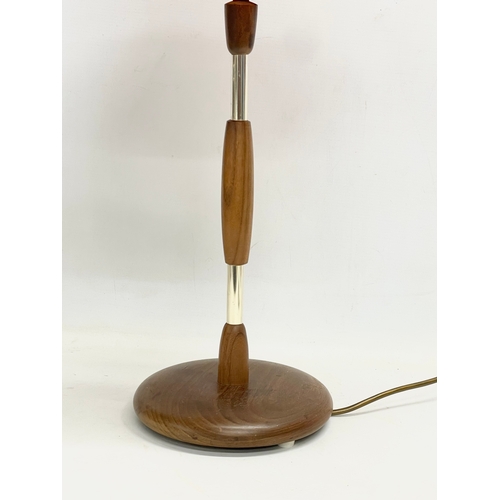 374 - A tall Mid Century teak table lamp. 69cm