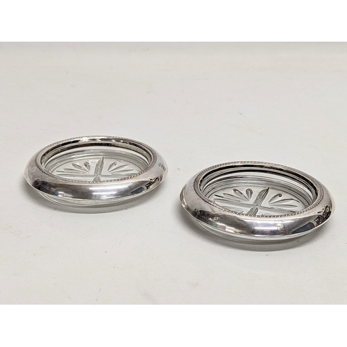 191 - A pair of F. B. Rogers silver and glass coasters. 10cm