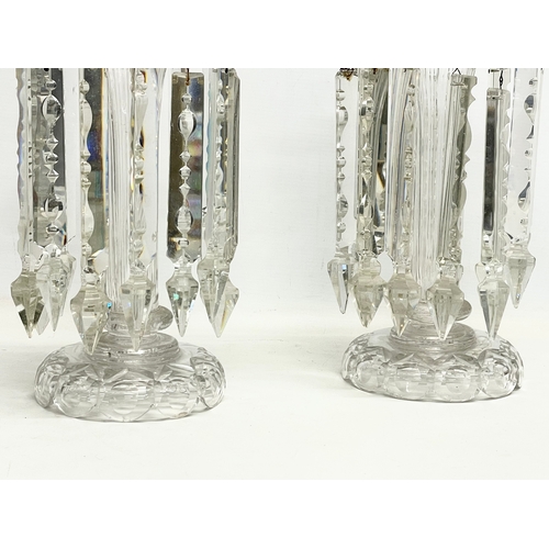 385 - A pair of large Victorian heavy cut glass lustres. 26x30.5cm.