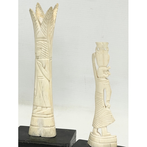 398 - 4 late 19th century carved bone ornaments on wooden stand. 21cm.