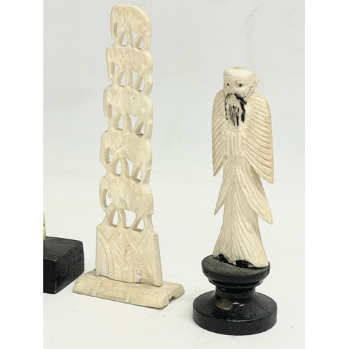 398 - 4 late 19th century carved bone ornaments on wooden stand. 21cm.