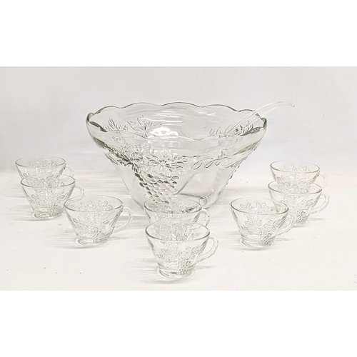 550 - 2 vintage punch bowls and cups, with serving spoons. 1 bowl measures 30x14.5cm