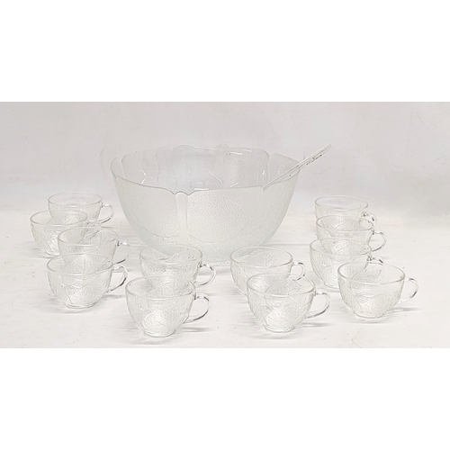 550 - 2 vintage punch bowls and cups, with serving spoons. 1 bowl measures 30x14.5cm