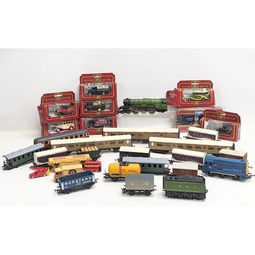 555 - A collection of train carriages including Hornby, with model die-cast toy cars