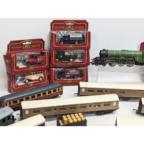 555 - A collection of train carriages including Hornby, with model die-cast toy cars