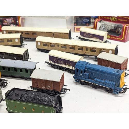 555 - A collection of train carriages including Hornby, with model die-cast toy cars