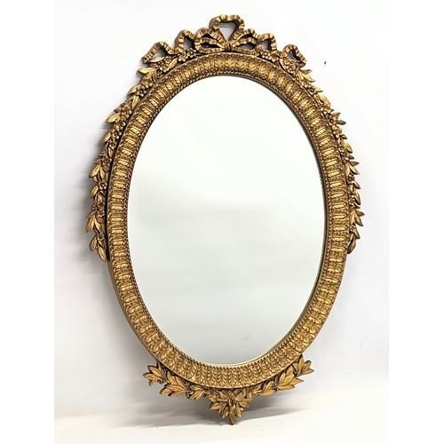 566 - A vintage ornate gilt framed mirror. 61x86cm