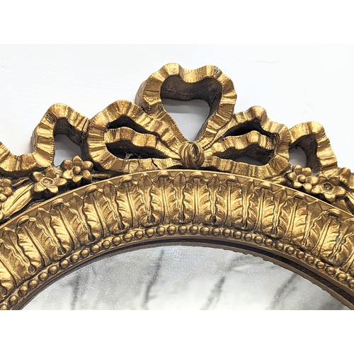 566 - A vintage ornate gilt framed mirror. 61x86cm