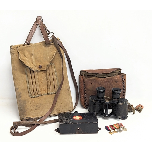 568 - A sundry lot containing a military map folder, field binoculars, military field first aid case, and ... 