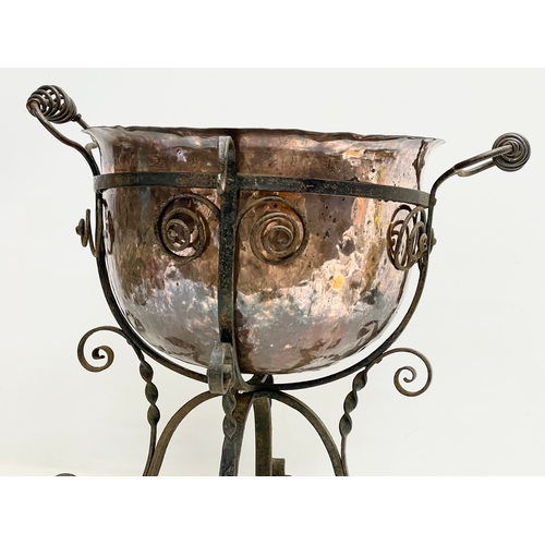 65A - A large late 19th century Art Nouveau copper planter in the original wrought iron base. 49x45x44cm