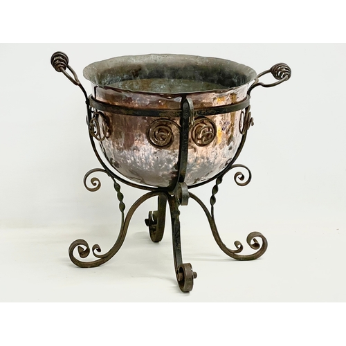 65A - A large late 19th century Art Nouveau copper planter in the original wrought iron base. 49x45x44cm