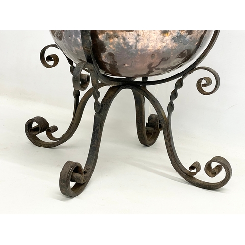 65A - A large late 19th century Art Nouveau copper planter in the original wrought iron base. 49x45x44cm