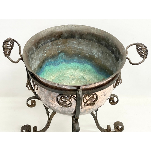 65A - A large late 19th century Art Nouveau copper planter in the original wrought iron base. 49x45x44cm