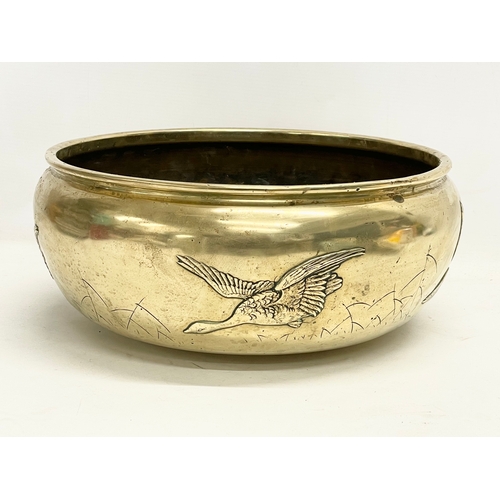 65B - A large late 19th century Japanese heavy brass bowl. 35x15cm