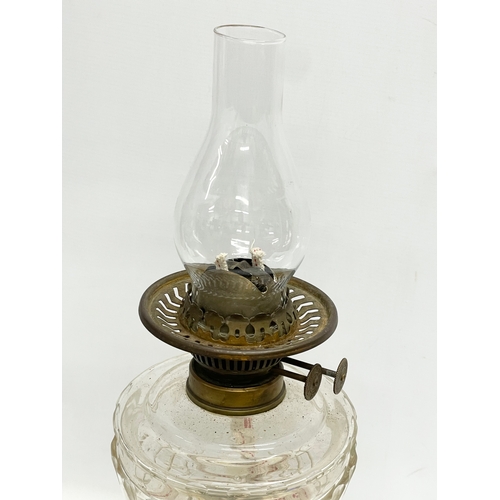 4 - A late Victorian double burner oil lamp with cut glass bowl and brass column. 57cm