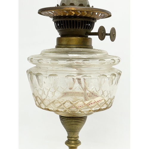 4 - A late Victorian double burner oil lamp with cut glass bowl and brass column. 57cm