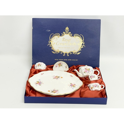 7 - A Royal Crown Derby ‘Derby Posies’ miniature porcelain tea set in box. Tray measures 22x17cm.