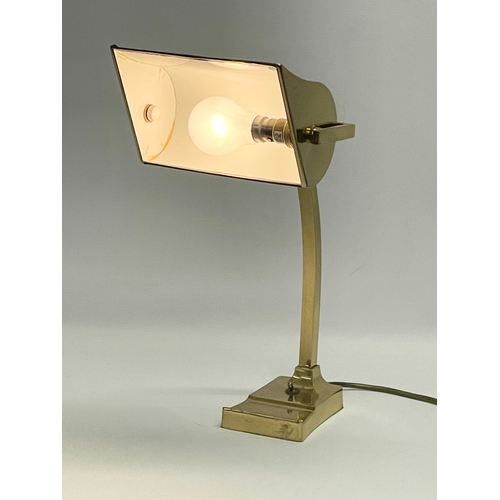 11 - A large good quality brass desk lamp with leather shade. 22x29x40.5cm