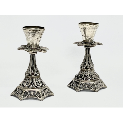 305 - A pair of ornate silver candlesticks. 60.7 grams. 7.5cm