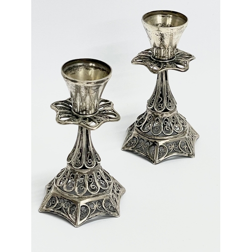 305 - A pair of ornate silver candlesticks. 60.7 grams. 7.5cm