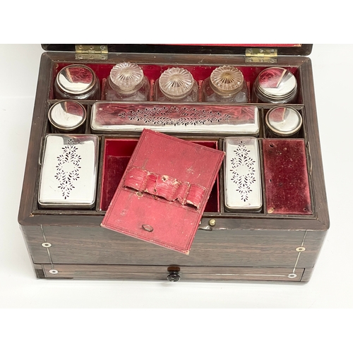 16 - A Victorian rosewood vanity box with Mother of Pearl inlay and cut glass bottles with silver plated ... 