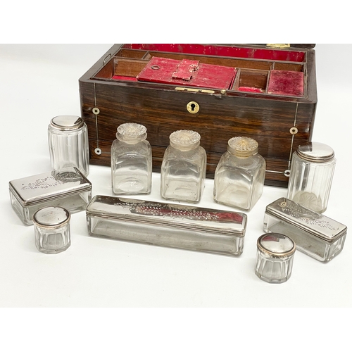 16 - A Victorian rosewood vanity box with Mother of Pearl inlay and cut glass bottles with silver plated ... 