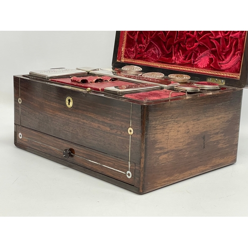 16 - A Victorian rosewood vanity box with Mother of Pearl inlay and cut glass bottles with silver plated ... 